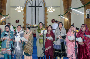 Group photo of Christian community members on Christmas Day at St. Thomas Church.