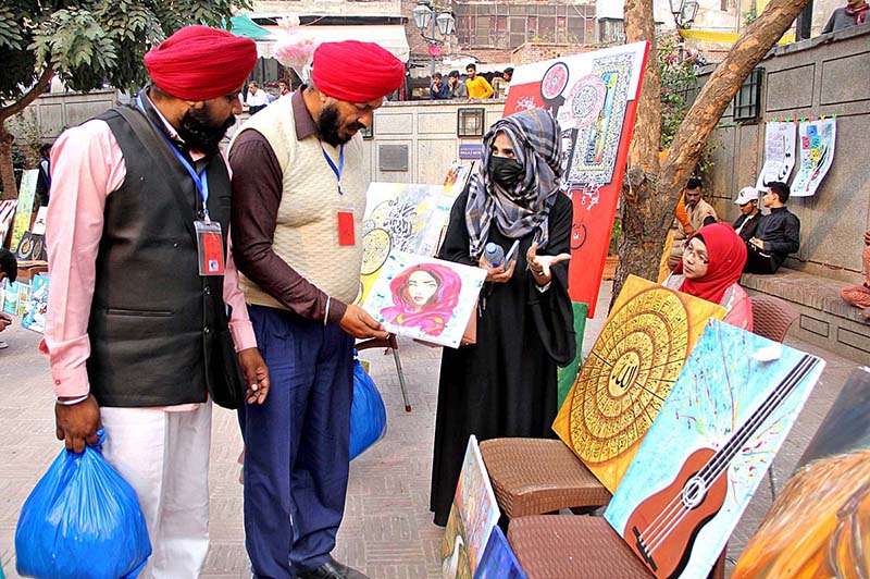 People viewing Painting exhibition organized by Bab-e-Pakistan Foundation and Walled City Authority at Wazir Khan Mosque Delhi Gate
