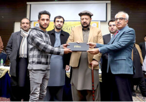 Chief Minister Gilgit-Baltistan Haji Gulbar Khan giving away laptops to Students during the Distribution Ceremony of Prime Minister Youth Laptop Scheme 2023 at Karakoram International University