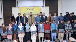 Chief Minister Gilgit-Baltistan Haji Gulbar Khan in a group photo with students during the Distribution Ceremony of Prime Minister Youth Laptop Scheme 2023 at Karakoram International University