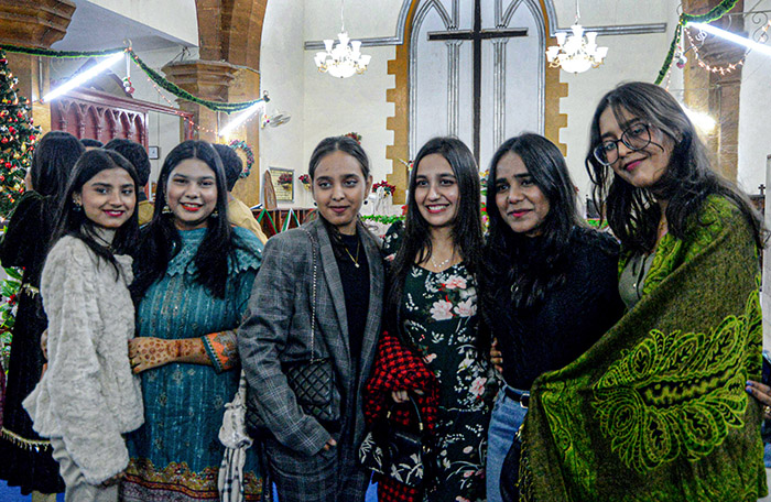 Group photo of Christian community members on Christmas Day at St. Thomas Church.