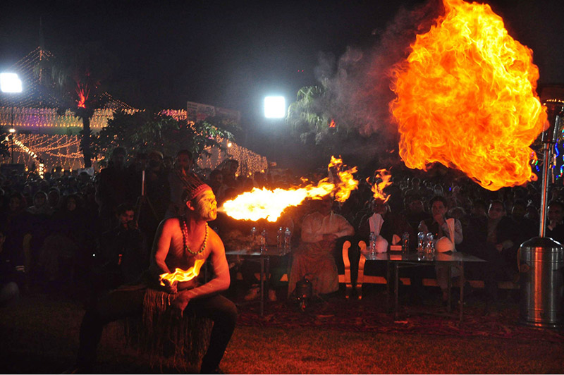 A juggler showcasing his skills during Lok Mela organized by the Parks and Horticulture Authority