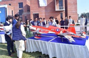 Student viewing an exhibition of plane models at Air University during International Civil Aviation Day was officially designated by the United Nations General Assembly in 1996