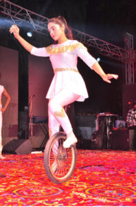 A juggler showcasing his skills during Lok Mela organized by the Parks and Horticulture Authority