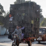 A tricycle rickshaw overloaded with plastic crates at LMQ Road which may cause any mishap and need attention of the authorities