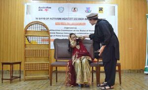 Students performing drama on stage during the closing ceremony of the 16 Days of Activism Against Gender-Based Violence, organized by the Khyber Pakhtunkhwa Commission on the Status of Women KPCSW.