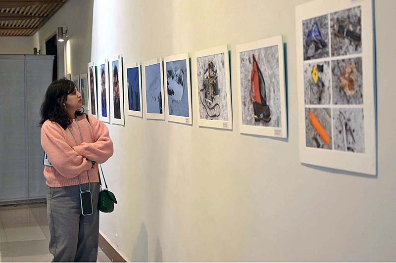 Visitor taking keen interest in the photographs during the “Mountain Photographic Exhibition” organized by Pakistan Tourism Development Corporation (PTDC) on the occasion of International Mountain Day 2023 at Pakistan Nation Council of Arts (PNCA)