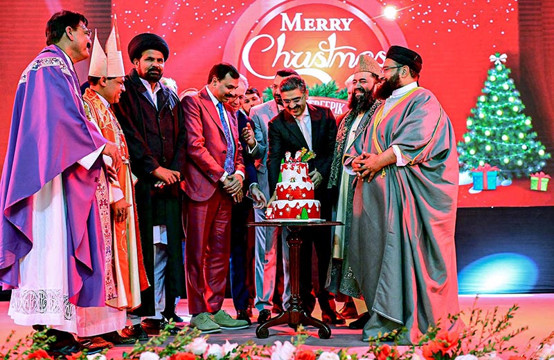 Caretaker Prime Minister Anwaar-ul-Haq Kakar cutting a cake as part of Christmas celebrations at an event organized by the Ministry of Human Rights