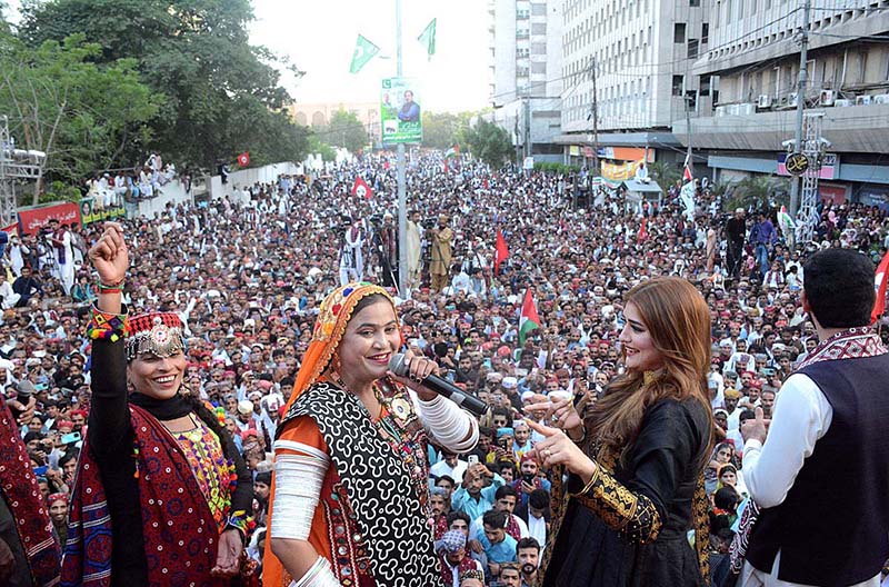 Folk singer performing Sindhi song during celebration of Sindhi Ajrak Topi Culture Day at Karachi Press Club