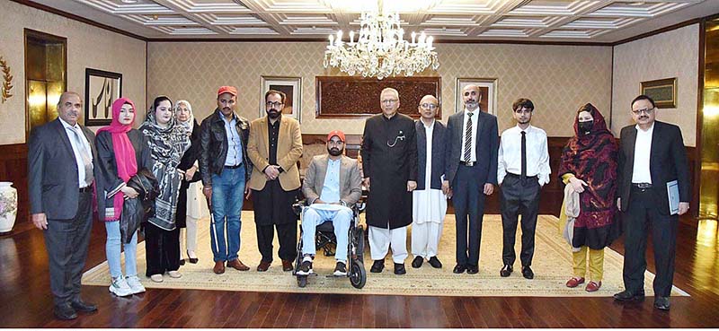 President Dr. Arif Alvi in a group photo with a delegation of Center for Peace and Development Initiatives comprising of social activists and persons with disabilities at Aiwan-e-Sadr
