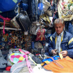 A tailor is mending jackets and bags at his workplace in Kalala Gujar Singh.