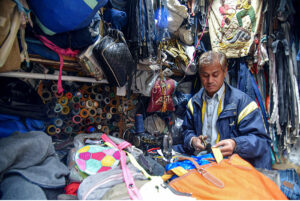 A tailor is mending jackets and bags at his workplace in Kalala Gujar Singh.