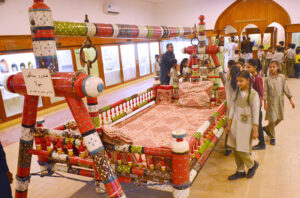Children observing the Sindhi cultural swing model at the Shah Latif Festival for Children at Sindh Museum