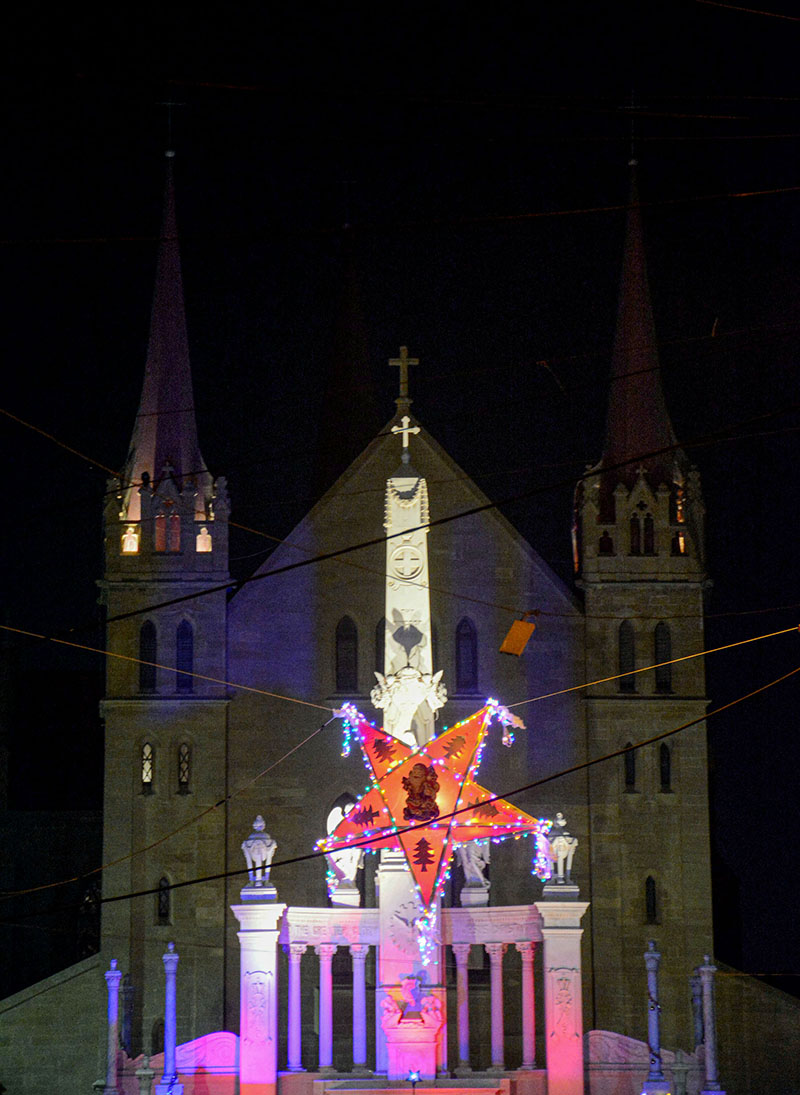An illuminated view of Holy Trinity Church decorated with colorful lights on the eve of Christmas