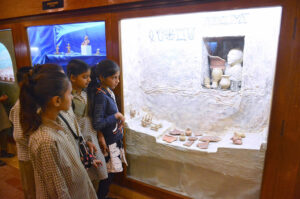 Children observing the Sindhi cultural swing model at the Shah Latif Festival for Children at Sindh Museum