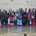 Sindhi writers, intellectuals and Sindhi folk singers throwing rose petals in the Indus River during last sunset of 2023 at Almanzar Picnic Point