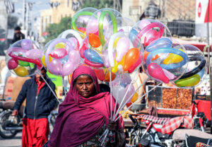A women vendor displaying balloons to attract the customers at Royal Road.