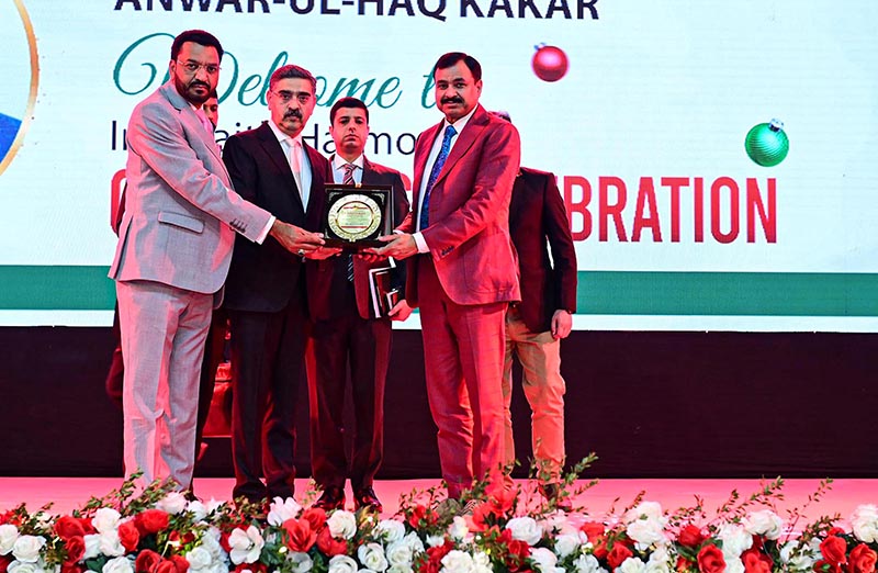 Caretaker Prime Minister Anwaar-ul-Haq Kakar receives a souvenir shield by the Caretaker Federal Minister of Human Rights Mr. Khalil George