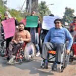 Special persons participate in a walk outside the Press Club on International Day of Persons with Disabilities.