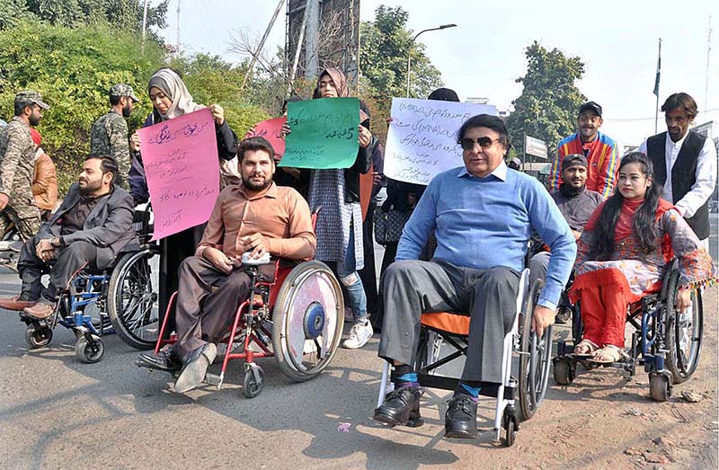 Special persons participate in a walk outside the Press Club on International Day of Persons with Disabilities.