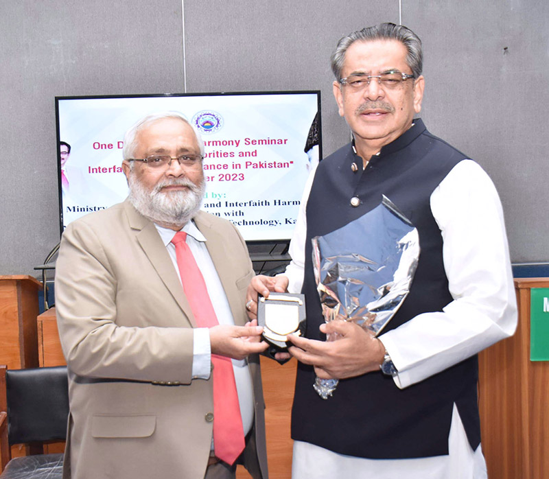 Caretaker Federal Minister for Religious Affairs and Interfaith Harmony Hon'ble Aneeq Ahmed is being presented a memento and a bouquet in a seminar on Religious Minorities and Interfaith Social Tolerance in Pakistan at NED University Karachi.