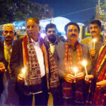 People light candles on the eve of Sindhi culture Day