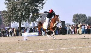 Horse riders are participating in a Tent-Pegging competition during the Winter Festival at MNS University