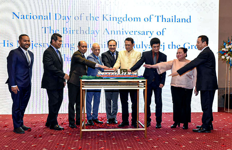 Caretaker Federal Minister for IT and Telecommunication Dr Umar Saif cutting cake at reception on the National Day of Thailand