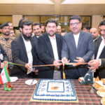Sindh Governor Kamran Khan Tessori cuts the ribbon for the inauguration of a direct flight from Karachi to Mashhad