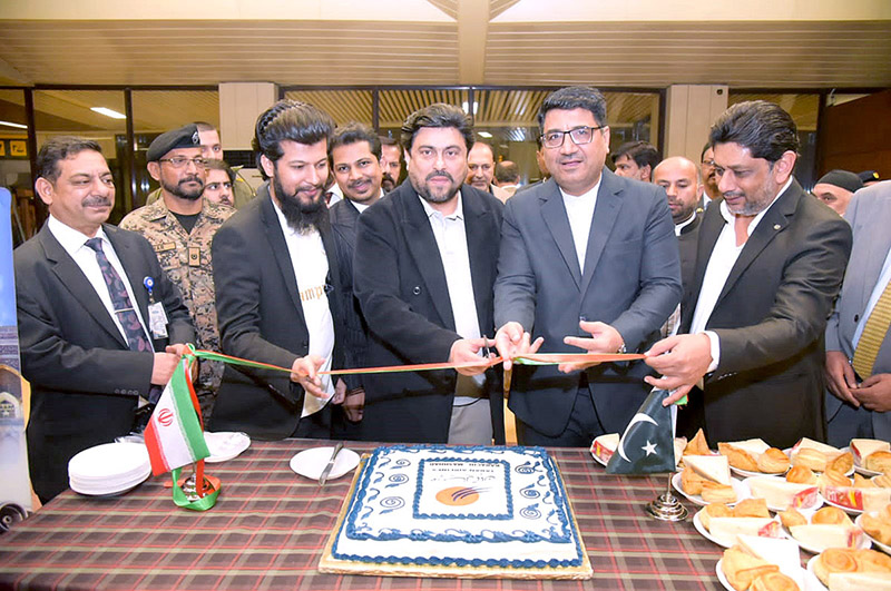 Sindh Governor Kamran Khan Tessori cuts the ribbon for the inauguration of a direct flight from Karachi to Mashhad