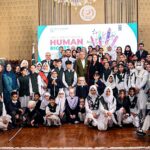President Dr Arif Alvi in a group photo with children at an event in connection with International Human Rights Day, at Aiwan-e-Sadr.