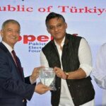 Consul General of the Republic of Turkiye, Cemal Sangu presenting memento to Dr. Junaid Ali Shah, Sindh Minister for Sports at Turkiye 100th Anniversary Celebration event. Eng Sami Abdullah Salim Al - Khanjari, Consul General of Oman also seen in picture