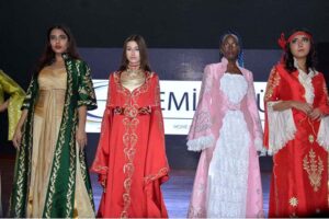 Models presenting the dresses designed by Turkish designer Cemile Gul at Turkiye 100th Anniversary Celebration event