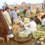 People buying Cauliflower at vegetable Market.