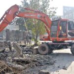Heavy machinery being used for repairing sewerage line at Commercial Market.