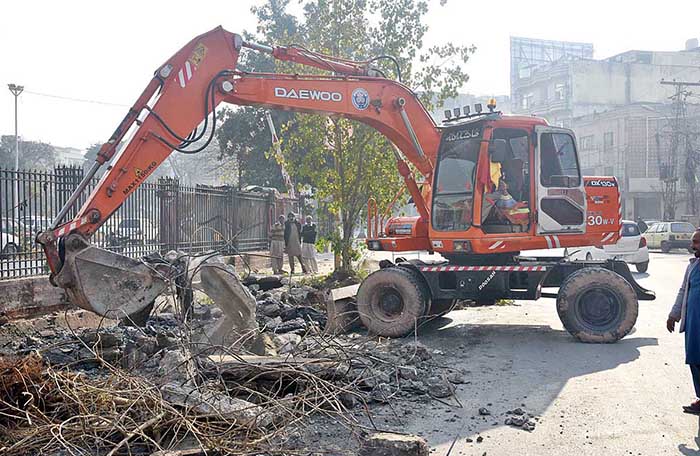 Heavy machinery being used for repairing sewerage line at Commercial Market.