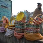 A vendor displaying handmade baskets for packing fruits to attract the customers at Fruit and Vegetable Market.