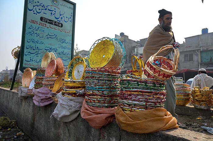A vendor displaying handmade baskets for packing fruits to attract the customers at Fruit and Vegetable Market.