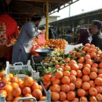 A vendor selling fruits at weekly Sunday bazar Aabpara in the Federal Capital
