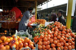 A vendor selling fruits at weekly Sunday bazar Aabpara in the Federal Capital