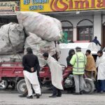 Traffic police official issuing challan to rickshaw loader driver due to overloading which is a violation of the traffic rule at Lathrar Road, Khana Pull.