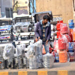 A local vendor displaying Gas and wooden stoves to attract the customers at the roadside.