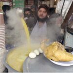 A vendor displaying chicken yakhni to attract the customers at his roadside setup during winter season in Federal Capital