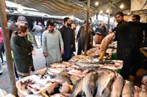 Vendor displaying fish to attract the customers at weekly Bazaar in the Federal Capital