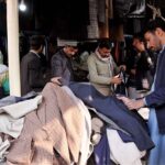 People purchasing used warm clothes at weekly Sunday bazar Aabpara in the Federal Capital