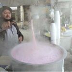 A vendor busy in making Kashmiri tea for customers at his roadside setup in Aabpara Market.