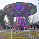 Children enjoying different swings at Public Park, Murree Road.