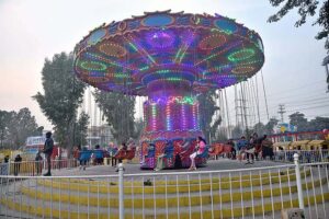 Children enjoying different swings at Public Park, Murree Road.