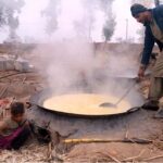 Farmer busy making traditional sweet item Gurr near Khushab Road