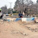 A view of damaged road being blocked at I-9 area creating problems for people and needs the attention of concerned authorities.